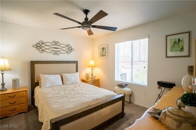 Carpeted bedroom with baseboards and ceiling fan