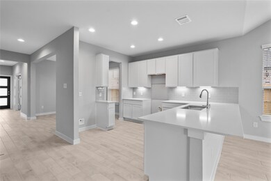 The open concept living room and kitchen makes for a great way to keep the party going and never miss a beat! Gather the family together in good conversation while preparing a fabulous meal in this breathtaking kitchen! Featuring high ceilings, light stained wood cabinets, granite countertops, SS appliances, modern tile backsplash, recessed lighting, and kitchen island with ample counter space!