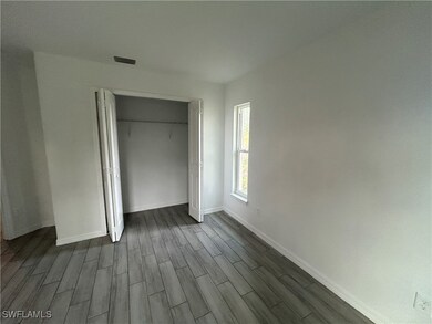 Unfurnished bedroom with dark wood-type flooring a