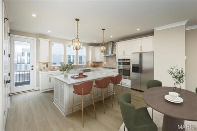 Kitchen with stainless steel appliances, decorative backsplash, a kitchen island, a kitchen breakfast bar, and light wood-type flooring