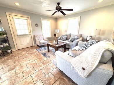 Living area with baseboards, crown molding, ceilin
