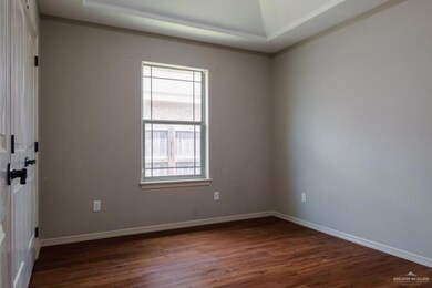 Empty room featuring dark hardwood / wood-style floors