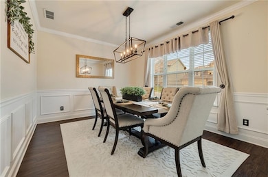 Dining space with a chandelier, ornamental molding