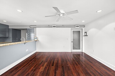 Unfurnished living room featuring wood-type floor