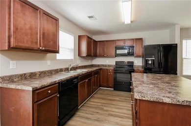 Kitchen featuring light wood finished floors, a si