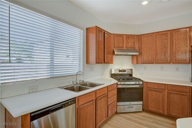 Kitchen with light wood finished floors, under cab