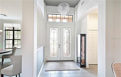 Gorgeous chandelier, leaded glass doors, and wood 