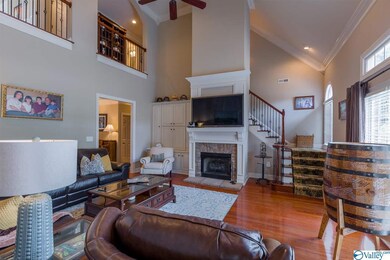 Fireplace with gas log insert, built-ins, 19' vaulted ceiling.