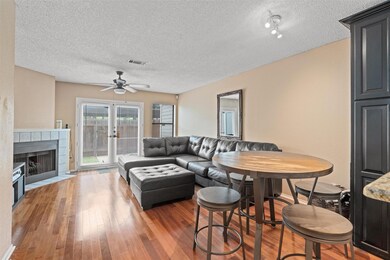 Living room with a textured ceiling, a ceiling fa