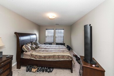 Bedroom featuring a textured ceiling and light col
