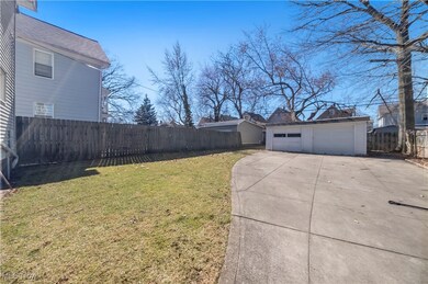 Virtually Staged View of yard with fence private yard, a detached garage, and an outdoor structure