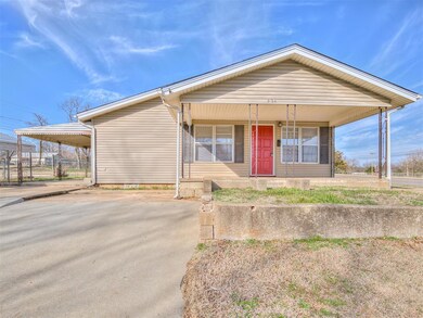 View of front of home with a carport and a porch
