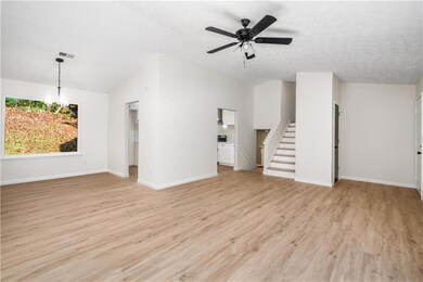 Unfurnished living room featuring lofted ceiling, 