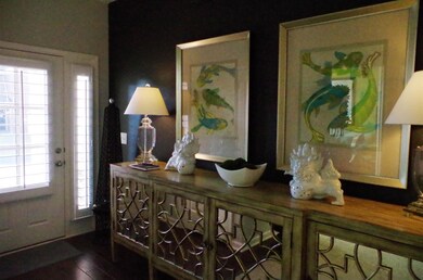 Walking in through the front door to a very stylist foyer area with one wall accented with a black/gray color. Beautiful!