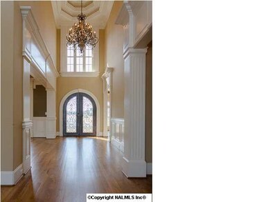 Two story entrance foyer with dramatic triple crown molding and romance lighting.