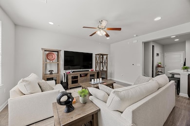 Living area featuring wood finished floors, reces