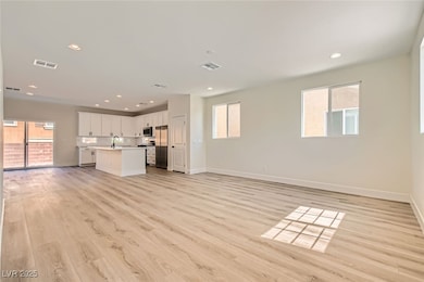 Unfurnished living room with light wood-style floo
