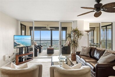 Living area featuring a wall of windows, ceiling fan, and tile patterned flooring