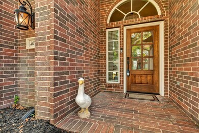 Welcoming you home, this elegant entryway features a beautifully crafted wooden and glass front door.