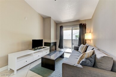 Living area with light tile patterned floors, a te