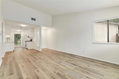 Unfurnished living room with light wood-style flo