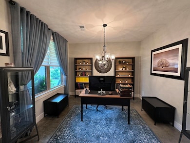 Office space featuring baseboards and a chandelier