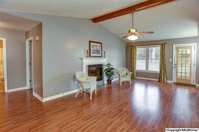Walk into this inviting space with attractive, laminate wood flooring with a brand-new, updated ceiling fan and light fixture.