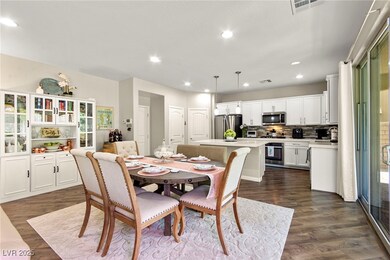 Dining room with dark wood-style floors and recess