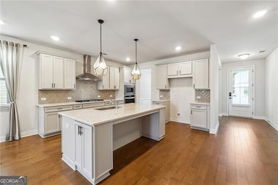 Kitchen featuring tasteful backsplash, a sink, wal