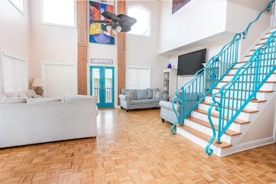 Foyer entrance with stairs and a high ceiling