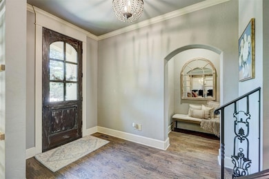 Foyer entrance featuring arched walkways, wood fin