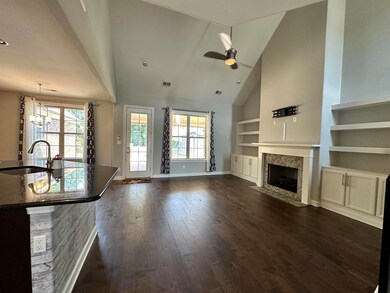 Unfurnished living room with built in shelves, dar