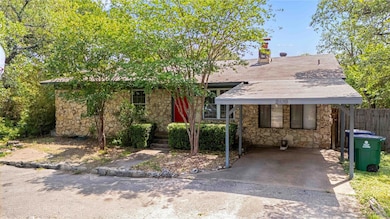 View of front of home with stone siding and a chi