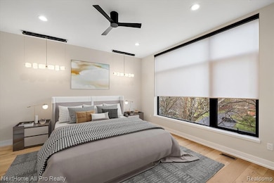 Primary Bedroom featuring light wood-type flooring, a ceiling fan, and recessed lighting
