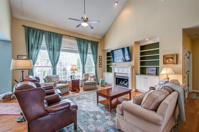 The family room is open to the kitchen, has lovely