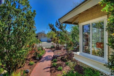 Large front yard with gorgeous landscaping and wal