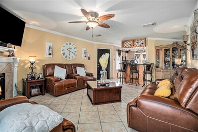 Spacious and inviting living room. Crown Molding throughout home.