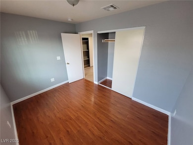Unfurnished bedroom with wood finished floors and