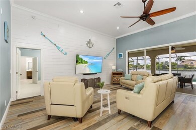 Living room featuring visible vents, ornamental mo