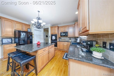 Large kitchen with granite countertops and hardwood flooring.