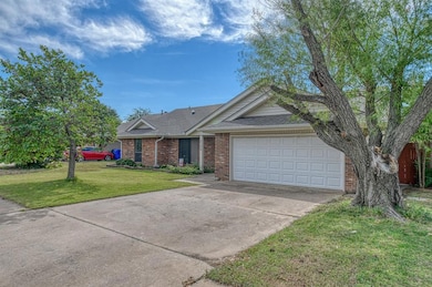 Ranch-style home with a garage and a front lawn