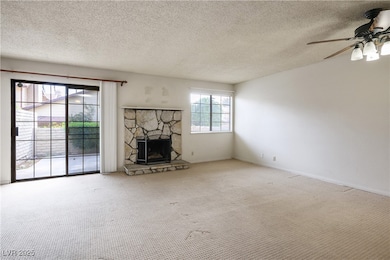 Unfurnished living room featuring a textured ceili