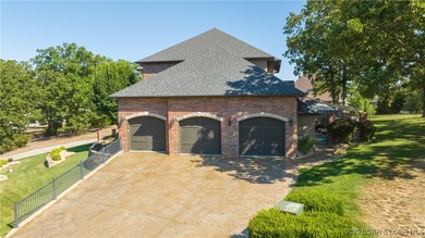 Large car garage with big stamped concrete driveway