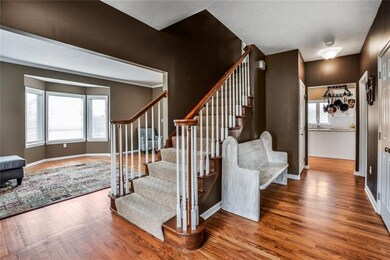 The inviting entry boasts gleaming hardwood floori