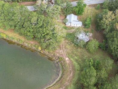 Cabin & outbuildings next to pond
