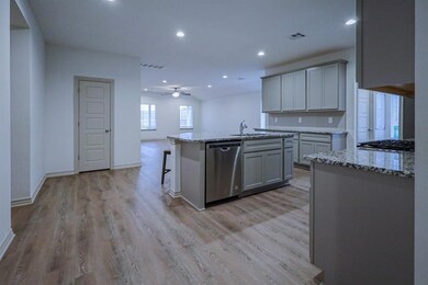 Kitchen featuring gray cabinets, a center island w