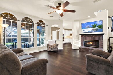 The main living room is spacious and has a wall of windows that look out to the private backyard. The room has new luxury vinyl plank flooring and oversized baseboards that were installed last month.