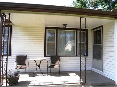 The covered front porch shelters and welcomes gues