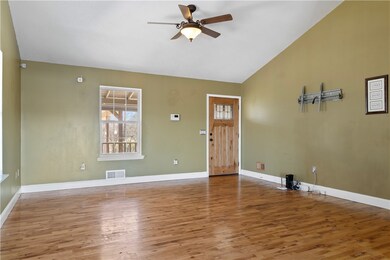 Open living area with cathedral ceiling.
