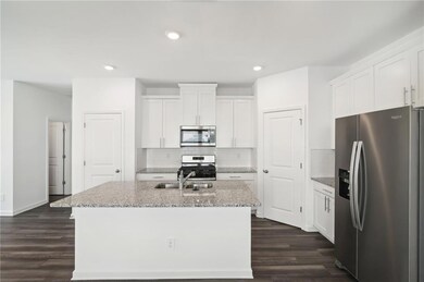 Kitchen with a kitchen island with sink, stainless